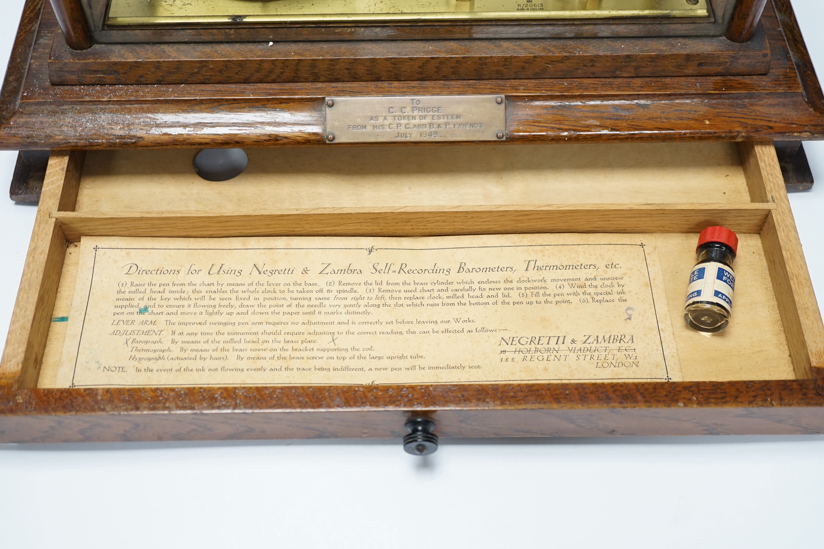 A Negretti and Zambra oak-cased barograph, number R/20613 with plaque reading ‘To C.C. Prigge as a token of esteem from his C.P.C. and B&P friends, July 1949’
